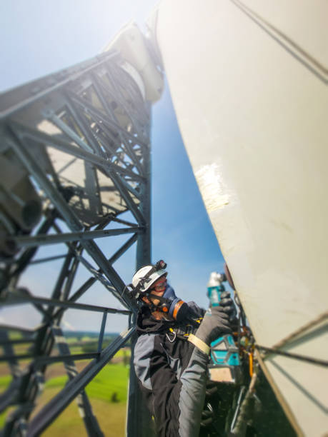 istock Epic view on professional Rope access technicians working on blade of wind turbine on the ropes, doing blade reapir. 2156816083