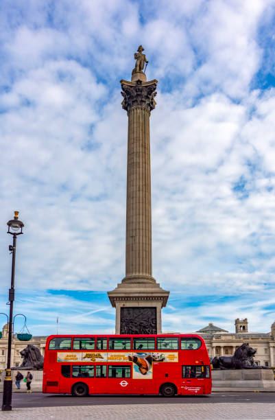 London, UK - 26 April 2024: Nelson's column on Trafalgar square and double-decker bus