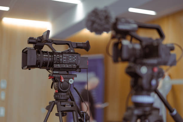 istock Two broadcast cameras ready on a tripod for a conference or live event or stream. Popularity of live stream is rising, so is equipment 2156817365