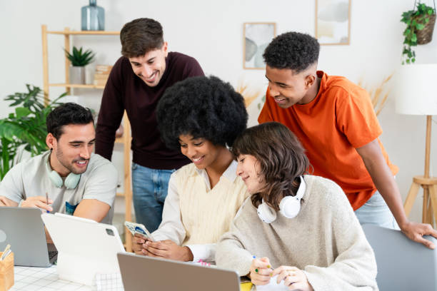 istock A group of young professionals work together on a project, using laptops and smartphones 2156819936