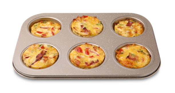 istock Freshly baked bacon and egg muffins with cheese in tin isolated on white 2156819978