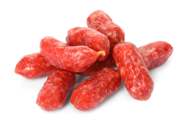Many thin dry smoked sausages isolated on white