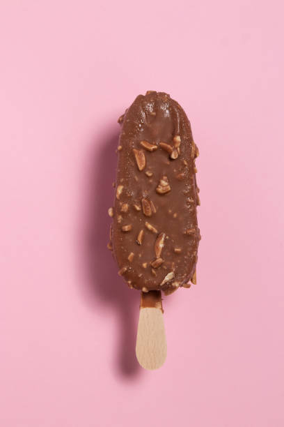 istock Ice cream covered with chocolate and almonds on pink background 2156820391