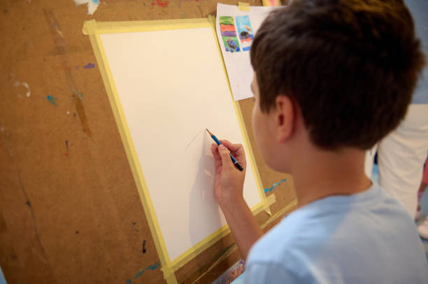 istock Child drawing and painting during art class in a creative workshop 2156822810