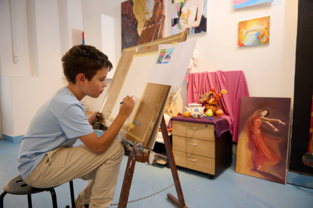 istock Child enjoying creative art class, drawing and painting in a vibrant studio 2156827705