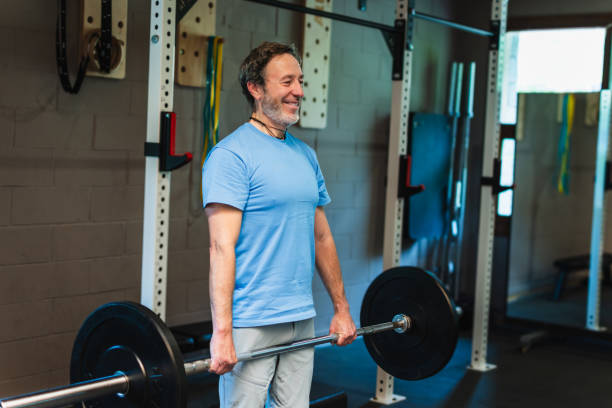 istock A senior man is lifting a barbell in a gym 2156830314