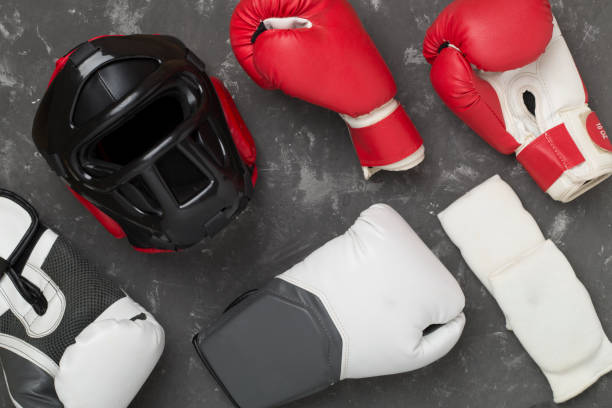 istock Boxing helmet and gloves on concrete background, top view. 2156831346