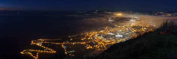 istock Panoramic view over the city at mediterranean coast from Monte Sant'Elia viewpoint during evening twilight at night, Palmi, Calabria, Italy 2156836590