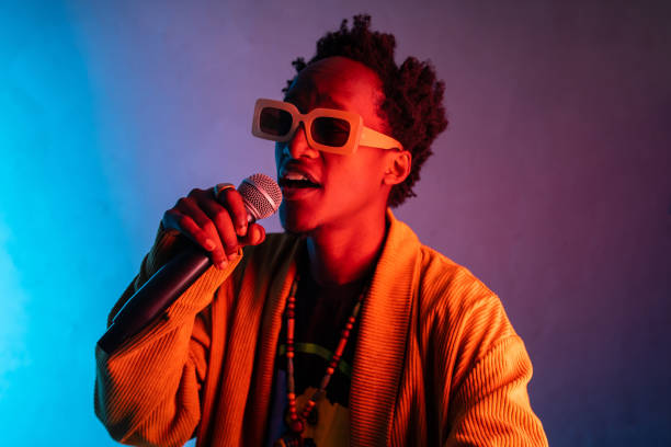 istock Man wearing sunglasses singing into a microphone 2156837730