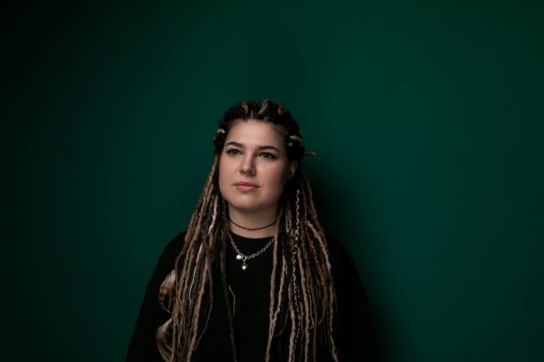 istock Woman With Dreadlocks Standing in Front of Green Wall 2156837923