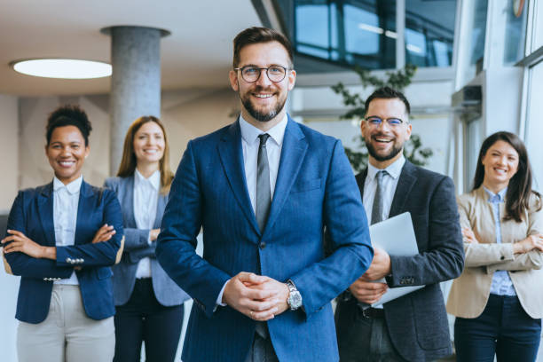 istock Professionals in office attire with male leader 2156837969