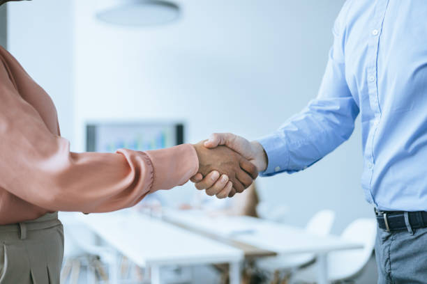 istock Meeting success. Two business persons shaking hands 2156837978