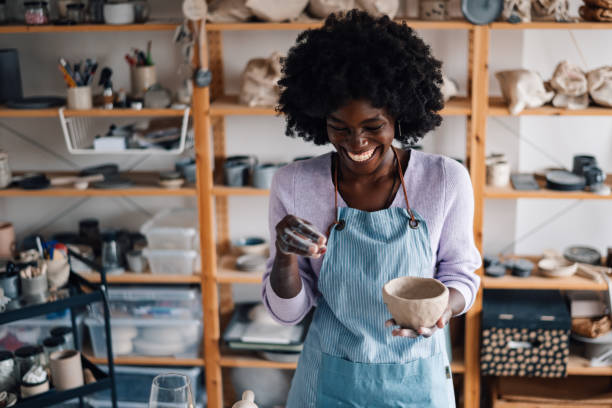 istock Diverse artisan standing at pottery atelier with clay work and laughing 2156838268