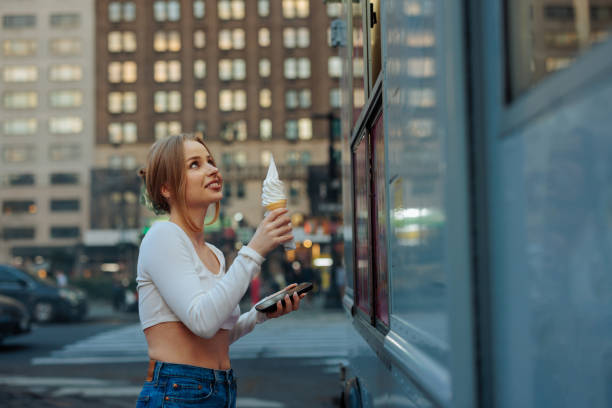 istock Happy woman looking at ice cream cone 2156838750