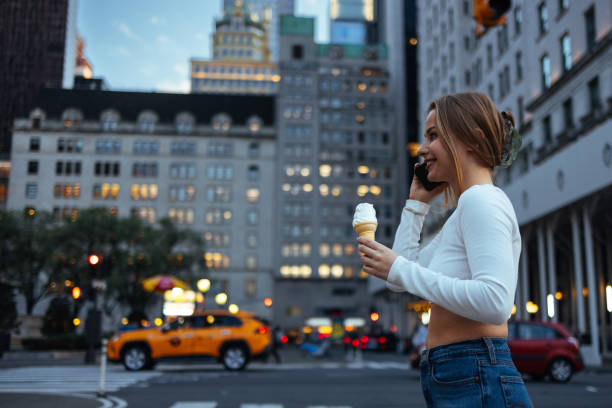 istock Woman eating ice cream in urban setting 2156838764