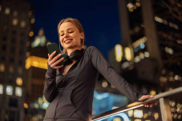 istock Relaxed woman using phone with cityscape 2156838784