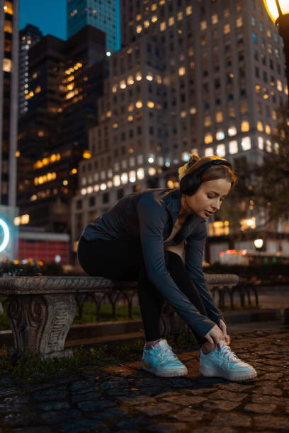 istock Athlete tying shoes on urban bench 2156838785