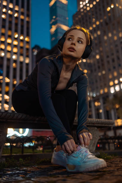 istock Runner crouching to tie shoe lace 2156838806