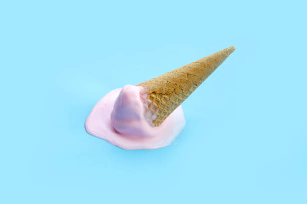 istock Melting ice cream ball with waffle cone on blue background. 2156839803