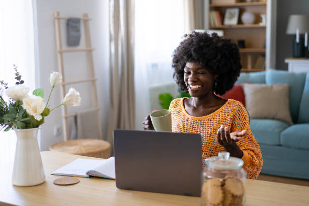 istock Young woman drinking coffee and having a video conference 2156840175