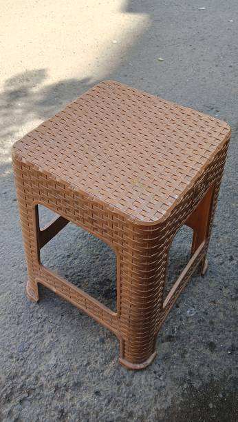 istock brown plastic chairs at a street stall. close up. 2156840988