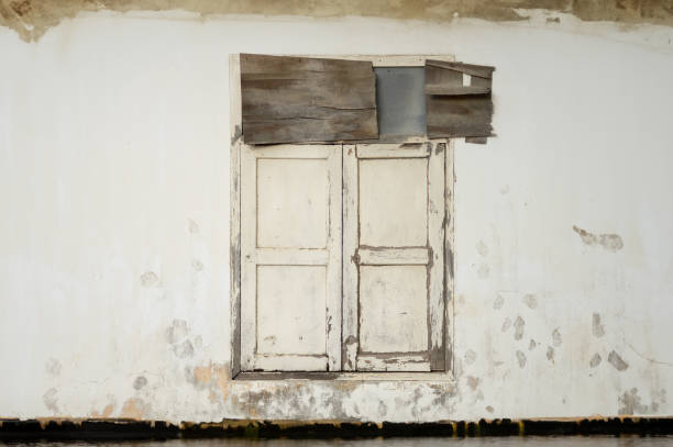 istock old wooden window on cement wall 2156841067