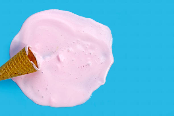 istock Melting ice cream ball with waffle cone on blue background. 2156843118