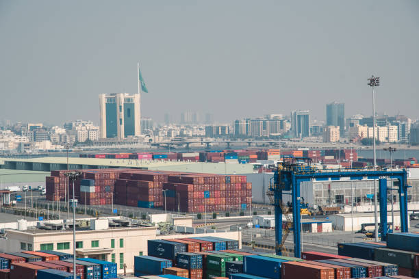 Jeddah, Saudi Arabia - December 12, 2022: A bustling port scene with stacked containers foregrounding Jeddahâs skyline.