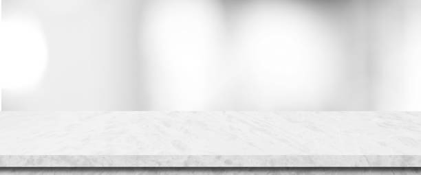 istock Empty white table top, counter, desk background over blur perspective bokeh light background, White marble stone table, shelf and blurred kitchen restaurant for food, product display mockup, template 2156849716