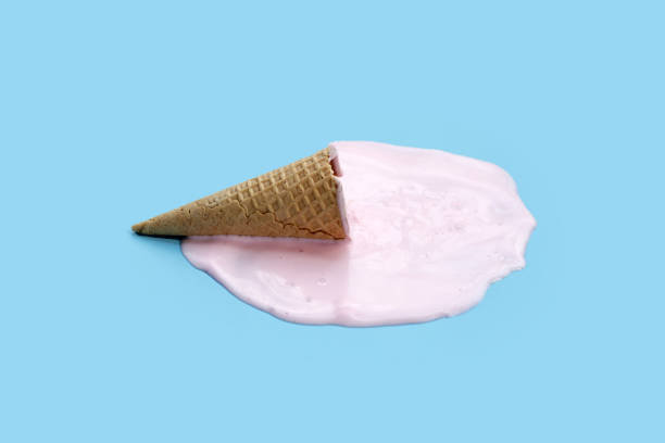 istock Melting ice cream ball with waffle cone on blue background. 2156851671