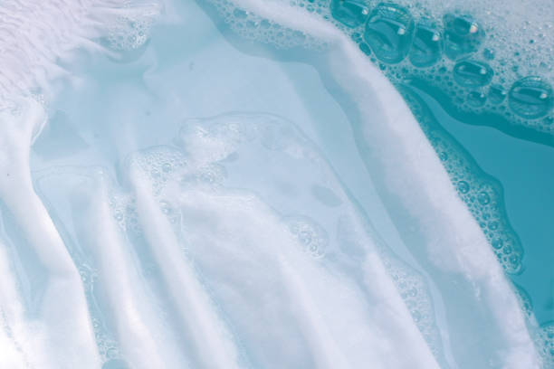 istock White cloth soaked in powder detergent water dissolution, washing cloth. Laundry concept 2156851703