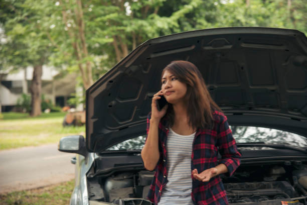 istock Women fix car call for help use phone calling insurance agent help fixing car problem breakdown. Woman calling mechanic car service technician support fix repair driving. Vehicle emergency problem 2156851792