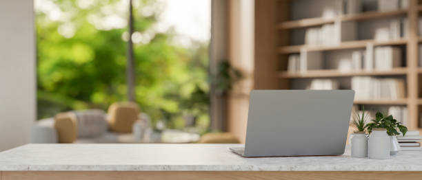 istock A laptop computer on a table in a modern, spacious living room or private CEO office. 2156853968