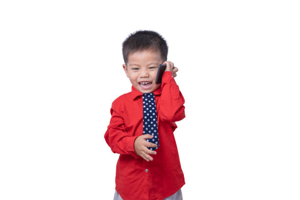 Adorable smiling little boy talking on smartphone isolated on white background. Concept of communication and Mother's Day love family lifestyle. Copy space
