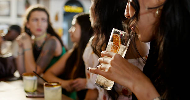 istock Beautiful Women Sip Fruity Drinks at a Bar - Daytime 2156859942