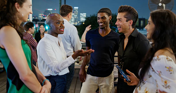 istock Beautiful Multi-Ethnic Friends Laugh on a Rooftop Patio Enjoying Conversation 2156859944