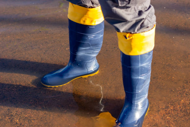 istock Blue and yellow rubber boots in the water 2156860600
