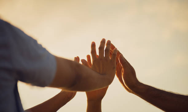 istock Close up people putting their hands together. Friends hands showing unity and teamwork, friendship, happiness and partnership team concept. 2156863637