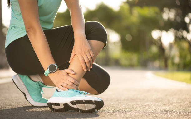 istock Ankle sprained. Young woman suffering from an ankle injury while exercising and running. Healthcare and sport concept. 2156863767