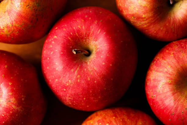 istock Ripe organic red apple on wooden table background. 2156864034