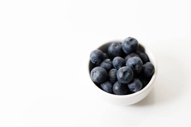 istock Ripe organic blueberries on white wooden table background. Selective focus. 2156864049