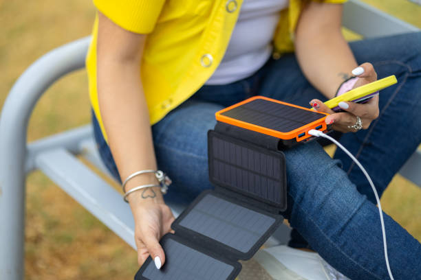 istock Woman using a Portable Solar Panels for her devices 2156865230