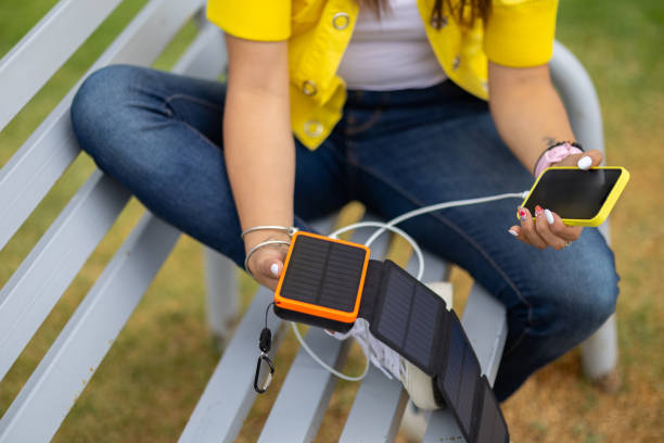 istock Woman using a Portable Solar Panels for her devices 2156865253