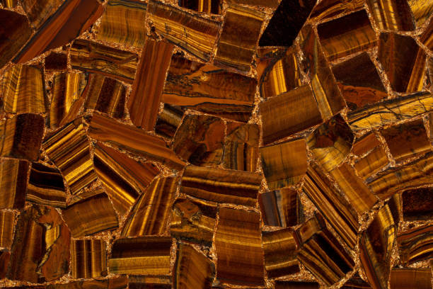 The wood is red and brown color with layers and lines like a rose petal. High angle view of a flat textured wooden board backgrounds. It has a beautiful nature and abstractive pattern. A close-up studio shooting shows details and lots of wood grain on the wood table. The piece of wood at the surface of the table also appears rich wooden material on it, shows elegant and soft textured. Flat lay style. Its high-resolution textured quality.