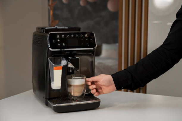 istock Man makes coffee on a coffee machine at home 2156868887