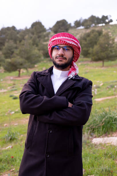 istock An Arab man in nature clears his mind and thinks positively about the future, surrounded by trees and clouds wearing a jacket due to change in climate 2156869862