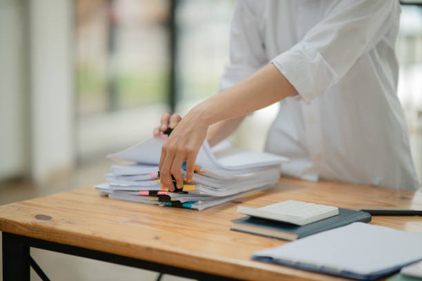 istock businesswoman Sitting and working on graph documents 2156870271