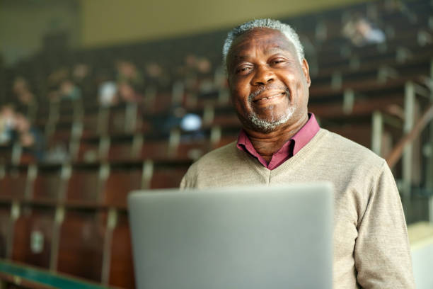 istock Happy black professor using laptop in lecture hall. 2156872548