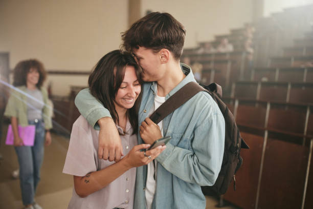 istock Happy university couple in love embracing in lecture hall. 2156872574