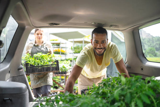 istock Diverse Duo Prepares Plants for Transport 2156879166